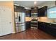 Well-equipped kitchen with stainless steel appliances, dark cabinetry, and hardwood floors at 1320 Double Oak Ln, Willow Springs, NC 27592