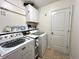 Clean laundry room featuring modern washer and dryer, cabinet storage, and ample shelving at 1320 Double Oak Ln, Willow Springs, NC 27592