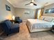 This spacious main bedroom features a ceiling fan, cool color accents and sitting area at 1320 Double Oak Ln, Willow Springs, NC 27592