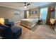 Cozy main bedroom with comfortable seating, soft carpet, and ample natural light at 1320 Double Oak Ln, Willow Springs, NC 27592