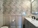 Stylish powder room featuring floral wallpaper, a modern vanity, and wainscoting at 1320 Double Oak Ln, Willow Springs, NC 27592