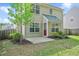 Charming backyard with a small patio, manicured lawn, privacy fence, and an entry door at 136 River Pearl St, Raleigh, NC 27603