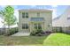 Spacious backyard featuring a cozy patio, lush green lawn, a fence, and mature landscaping at 136 River Pearl St, Raleigh, NC 27603