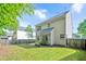 Serene backyard featuring a well-maintained lawn, wooden fence, and lush green trees at 136 River Pearl St, Raleigh, NC 27603