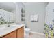 Well-lit bathroom with a single sink vanity, floral shower curtain, and neutral walls at 136 River Pearl St, Raleigh, NC 27603