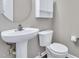 Cozy bathroom featuring a pedestal sink, toilet, and fresh paint at 136 River Pearl St, Raleigh, NC 27603