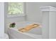 Inviting soaking tub with tub tray at 136 River Pearl St, Raleigh, NC 27603