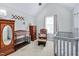 Well-furnished Bedroom with crib, dresser, and glider at 136 River Pearl St, Raleigh, NC 27603
