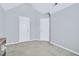 Bright bedroom featuring high ceilings, neutral walls, carpeted floors, and two entry doors at 136 River Pearl St, Raleigh, NC 27603