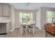 Bright dining room with wood-look floors, modern chandelier, neutral wall paint and white trim at 136 River Pearl St, Raleigh, NC 27603