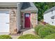 Close-up of a front door and sidelight with manicured landscaping and brick veneer at 136 River Pearl St, Raleigh, NC 27603