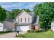 Charming two-story home featuring a two-car garage, brick accents, and manicured landscaping at 136 River Pearl St, Raleigh, NC 27603