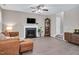 Open living room featuring fireplace, grandfather clock, and wood-look floors at 136 River Pearl St, Raleigh, NC 27603