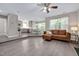 Open concept living space with wood-look floors, a brown sectional sofa, and a view of the kitchen at 136 River Pearl St, Raleigh, NC 27603