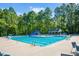 Beautiful community pool featuring clear blue water, lounge chairs, and a gazebo at 136 River Pearl St, Raleigh, NC 27603