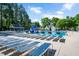 Community pool with plenty of lounge chairs, a gazebo, and a blue water slide at 136 River Pearl St, Raleigh, NC 27603