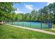 Community tennis courts and playground surrounded by trees and lush landscaping at 136 River Pearl St, Raleigh, NC 27603