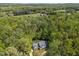 Aerial shot of home nestled among mature trees offers privacy and seclusion from neighbors at 1415 Meadow Wind Ln, Hillsborough, NC 27278