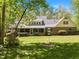 Large backyard with mature trees provides plenty of shade and privacy for outdoor enjoyment at 1415 Meadow Wind Ln, Hillsborough, NC 27278