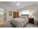 Bedroom featuring neutral carpet, a ceiling fan, and an entry to the staircase at 1415 Meadow Wind Ln, Hillsborough, NC 27278