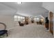Spacious bonus room features carpeted flooring, neutral paint, and plenty of natural light at 1415 Meadow Wind Ln, Hillsborough, NC 27278