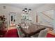 Elegant dining room with hardwood floors, stylish chandelier, and seamless flow to living spaces at 1415 Meadow Wind Ln, Hillsborough, NC 27278