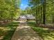 Charming brick home with a long driveway nestled amongst lush trees offers curb appeal at 1415 Meadow Wind Ln, Hillsborough, NC 27278