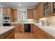 Well-lit kitchen boasts sleek countertops, wood cabinets, and modern black appliances at 1415 Meadow Wind Ln, Hillsborough, NC 27278