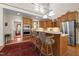 Bright kitchen with wood cabinets, stainless steel appliances, and a spacious breakfast bar for casual dining at 1415 Meadow Wind Ln, Hillsborough, NC 27278