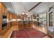 Spacious kitchen with custom wood cabinets, modern appliances, and large center island at 1415 Meadow Wind Ln, Hillsborough, NC 27278
