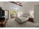 Serene main bedroom with vaulted ceiling, large windows, and a seating area for relaxation at 1415 Meadow Wind Ln, Hillsborough, NC 27278
