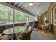 Covered porch with multiple ceiling fans and furniture with views of wooded backyard at 1415 Meadow Wind Ln, Hillsborough, NC 27278