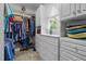 Organized walk-in closet with ample shelving, drawers, and hanging space, offering efficient storage solutions at 1415 Meadow Wind Ln, Hillsborough, NC 27278