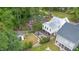 Aerial view of a backyard with a covered porch, patio with dining area, fire pit, and landscaping at 1422 Banbury Rd, Raleigh, NC 27607