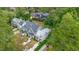 Expansive aerial view of a residential neighborhood with lush green trees and well-maintained properties at 1422 Banbury Rd, Raleigh, NC 27607