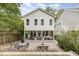Backyard with a covered porch, patio with dining area, fire pit, and surrounding landscaping at 1422 Banbury Rd, Raleigh, NC 27607