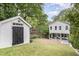 The backyard has a shed and a two-story house with a patio and seating under the porch at 1422 Banbury Rd, Raleigh, NC 27607