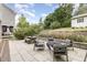 Backyard seating area featuring a picnic table, comfortable chairs, and a modern fire pit at 1422 Banbury Rd, Raleigh, NC 27607