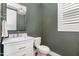 Powder room with marble countertop, modern fixtures, and neutral color palette at 1422 Banbury Rd, Raleigh, NC 27607