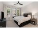 Well-lit bedroom with a ceiling fan, a plush bed, and large windows offering pleasant views at 1422 Banbury Rd, Raleigh, NC 27607