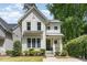 Charming two-story home with white siding, black trim, and a well-manicured lawn at 1422 Banbury Rd, Raleigh, NC 27607
