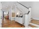 Bright foyer with hardwood floors, a staircase, and a custom storage bench at 1422 Banbury Rd, Raleigh, NC 27607