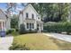 The two-story, white home has a driveway and lush landscaping, enhancing its curb appeal at 1422 Banbury Rd, Raleigh, NC 27607
