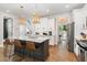 Bright eat-in kitchen features a large island, modern appliances, and stylish pendant lighting at 1422 Banbury Rd, Raleigh, NC 27607