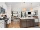 Open kitchen and living area, hardwood floors, stainless appliances, and marble countertops at 1422 Banbury Rd, Raleigh, NC 27607
