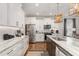 Modern kitchen with white cabinetry, stainless appliances, subway tile backsplash, and marble countertop at 1422 Banbury Rd, Raleigh, NC 27607