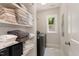 Laundry room with ample storage, featuring shelving stocked with linens and towels, with a modern washing machine at 1422 Banbury Rd, Raleigh, NC 27607