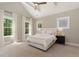 Bedroom with vaulted ceiling, carpet flooring, and large windows at 1422 Banbury Rd, Raleigh, NC 27607