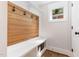 Mudroom with storage, bench seating, hooks, and natural light at 1422 Banbury Rd, Raleigh, NC 27607