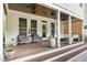 Rear exterior of a house with a cozy covered porch and a spacious wooden patio at 1422 Banbury Rd, Raleigh, NC 27607